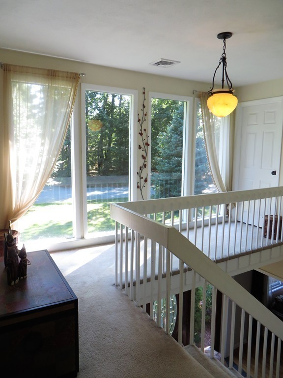 24 Raynor Road Sudbury, MA 01776 - Photo 12 of 30 a view of a porch with wooden floor and outdoor seating