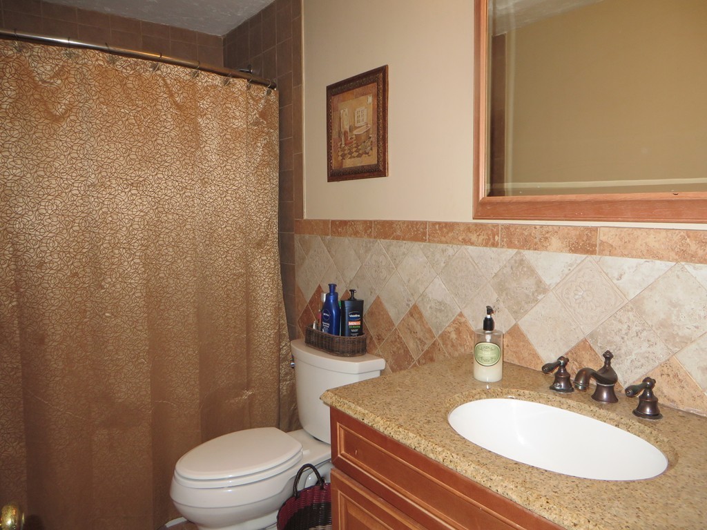 24 Raynor Road Sudbury, MA 01776 - Photo 14 of 30 a bathroom with a sink toilet and a mirror