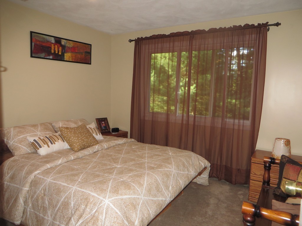 24 Raynor Road Sudbury, MA 01776 - Photo 18 of 30 a bedroom with a bed and a mirror