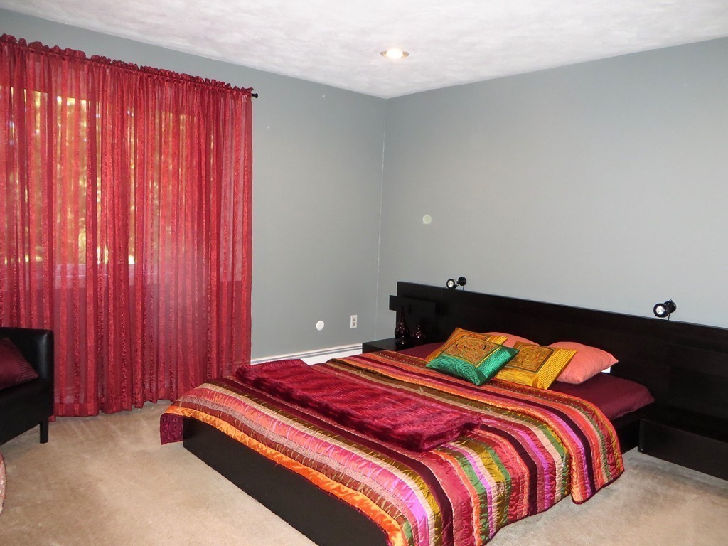 24 Raynor Road Sudbury, MA 01776 - Photo 19 of 30 a bedroom with a bed and curtain