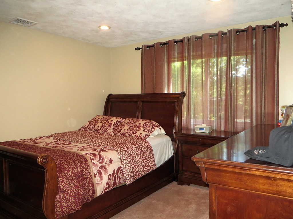 24 Raynor Road Sudbury, MA 01776 - Photo 20 of 30 a bedroom with a bed and window