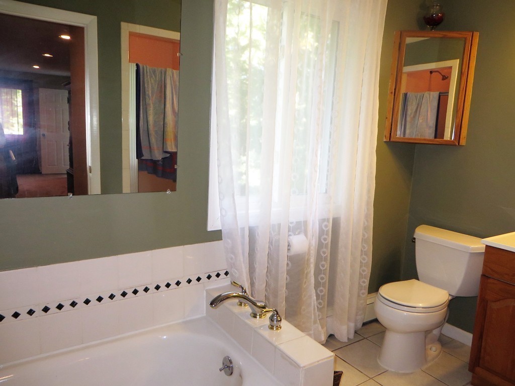 24 Raynor Road Sudbury, MA 01776 - Photo 21 of 30 a bathroom with a toilet a sink and a bathtub