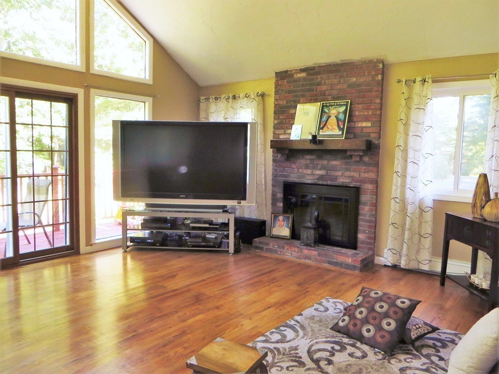 24 Raynor Road Sudbury, MA 01776 - Photo 24 of 30 a living room with furniture and a flat screen tv