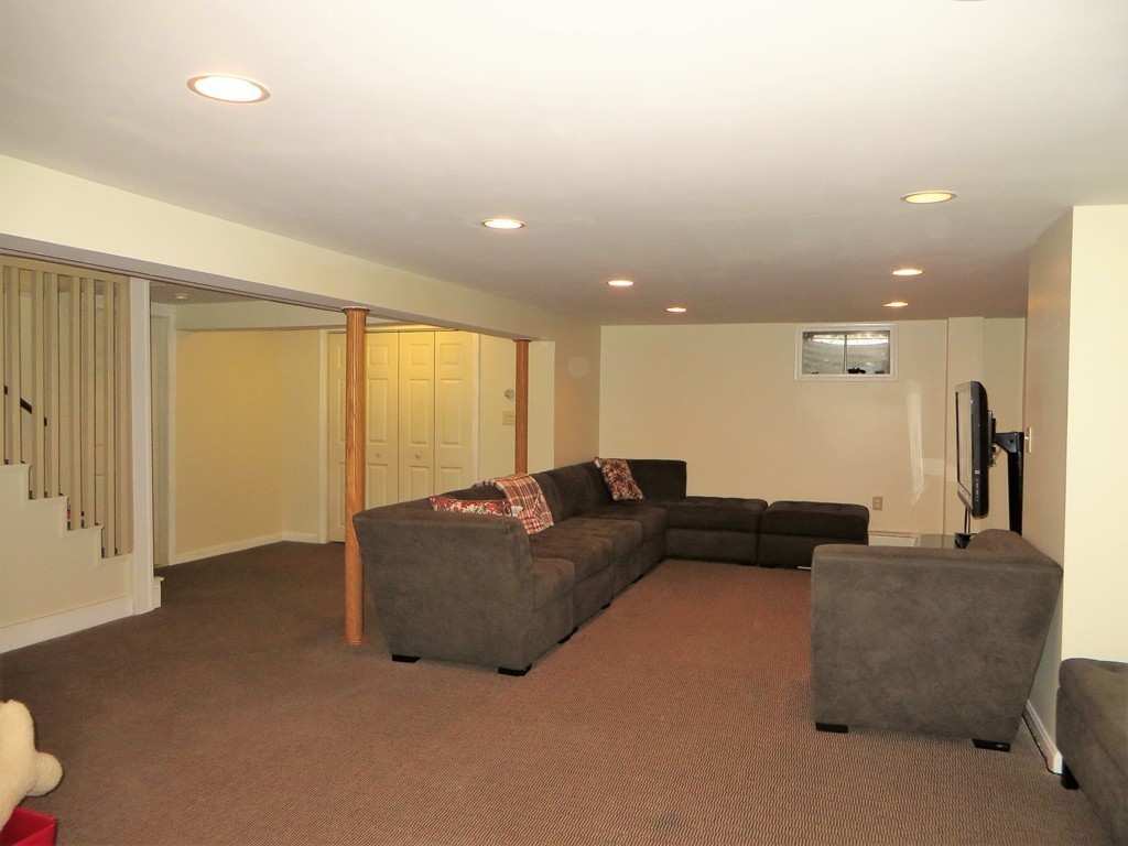 24 Raynor Road Sudbury, MA 01776 - Photo 27 of 30 a living room with furniture and a large window