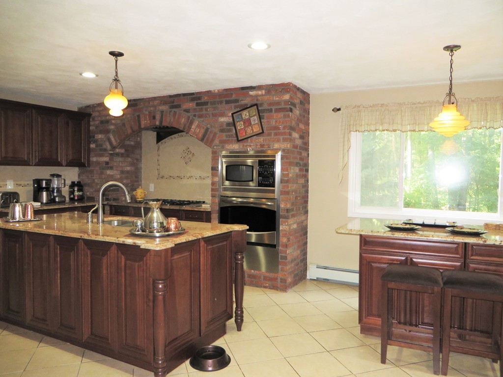 24 Raynor Road Sudbury, MA 01776 - Photo 3 of 30 a kitchen with stainless steel appliances granite countertop a stove a sink and a wooden cabinets