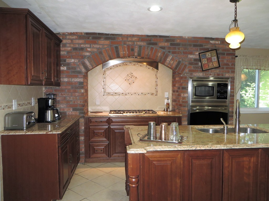 24 Raynor Road Sudbury, MA 01776 - Photo 4 of 30 a kitchen with stainless steel appliances granite countertop a sink and a stove