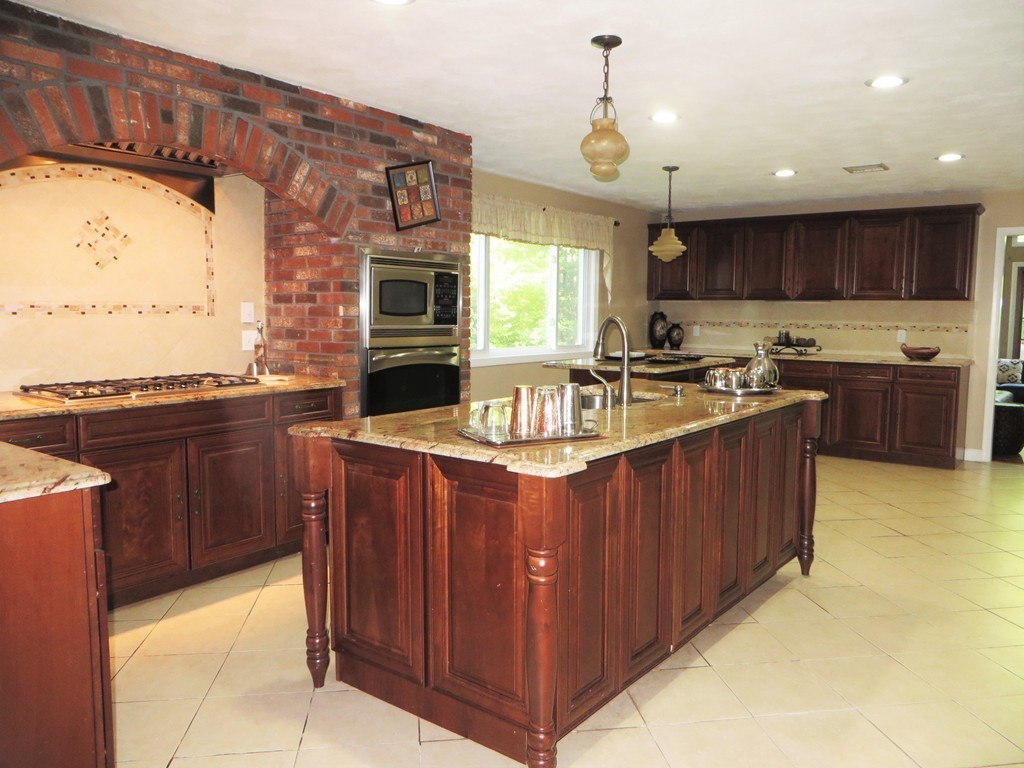 24 Raynor Road Sudbury, MA 01776 - Photo 6 of 30 a kitchen with a stove a sink and a refrigerator