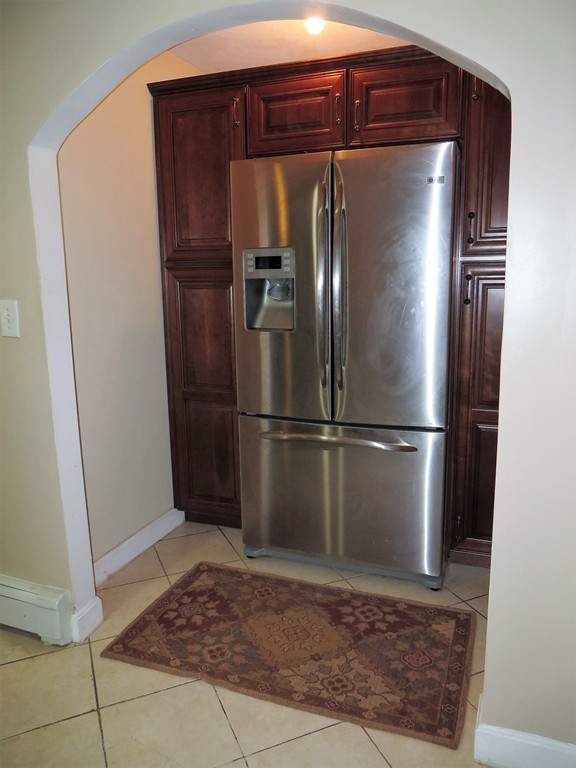 24 Raynor Road Sudbury, MA 01776 - Photo 8 of 30 a metallic refrigerator freezer sitting in a kitchen