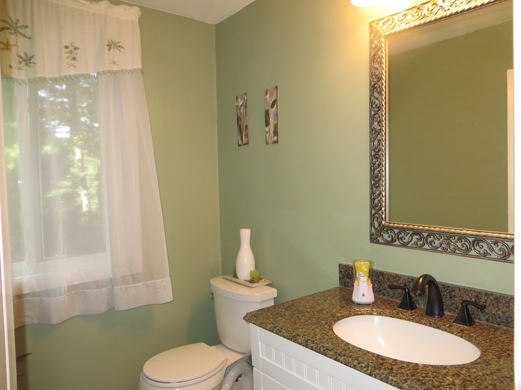 24 Raynor Road Sudbury, MA 01776 - Photo 9 of 30 a bathroom with a granite countertop sink and a mirror