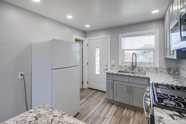 a kitchen with a sink stove and cabinets