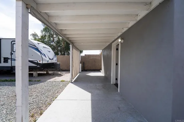 a kitchen with stainless steel appliances granite countertop a refrigerator a sink dishwasher a stove top oven a refrigerator and cabinets with wooden floor