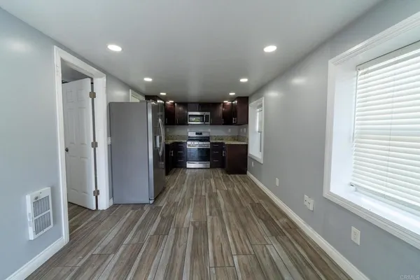 a kitchen with stainless steel appliances granite countertop a refrigerator a sink a stove and cabinets