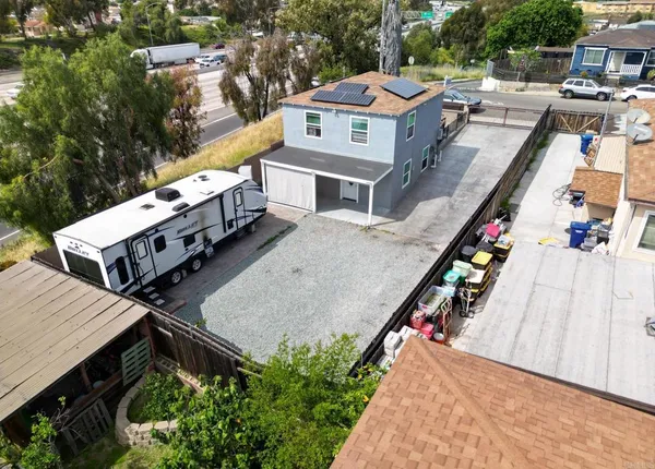 an aerial view of a house with a yard swimming pool and outdoor seating