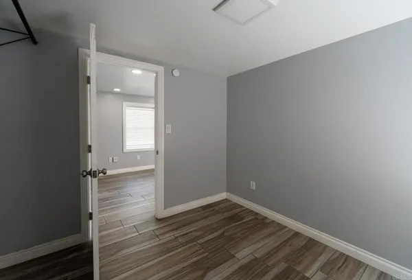 a view of a hallway with wooden walls and stairs