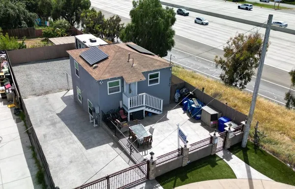 an aerial view of a house with a yard
