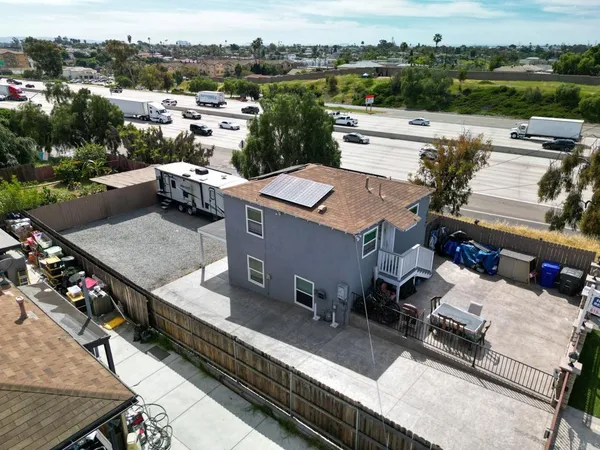 a view of a house with a yard and deck