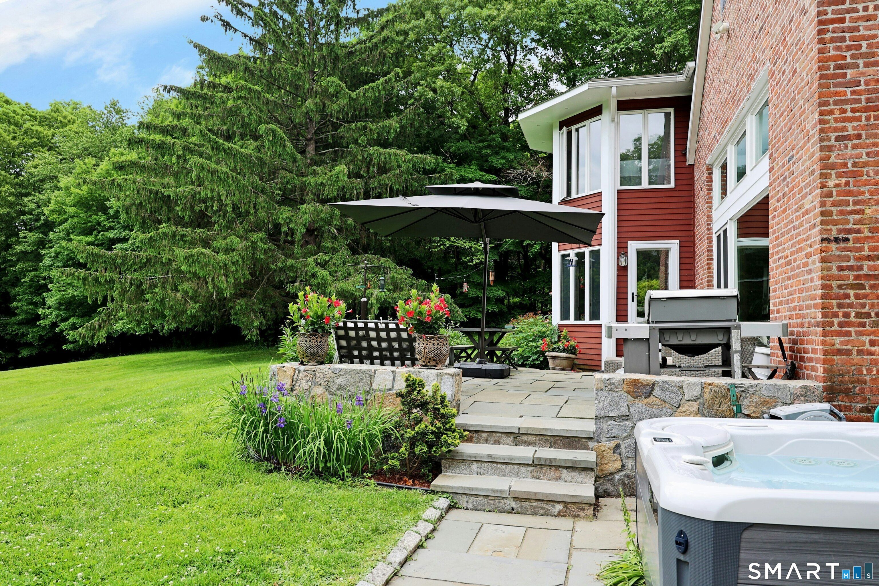 68 Bloomer Road Ridgefield, CT 06877 - Photo 4 of 40 a view of a patio with table and chairs potted plants and large tree