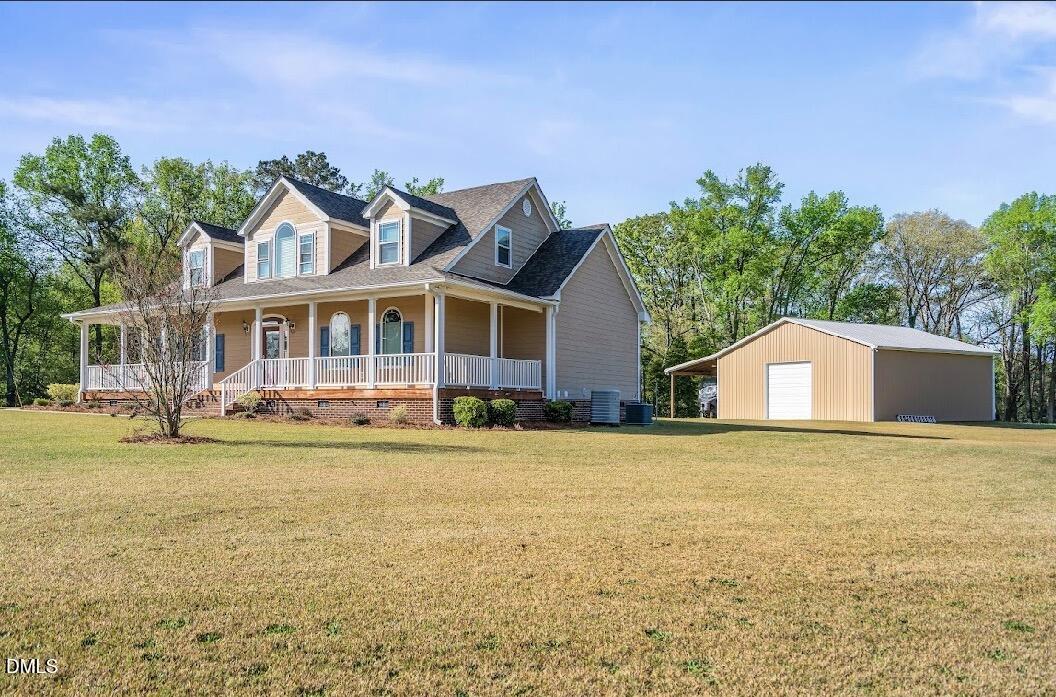 5780 McArthur Road Broadway, NC 27505 - Photo 3 of 40 a front view of a house with a garden and lake view