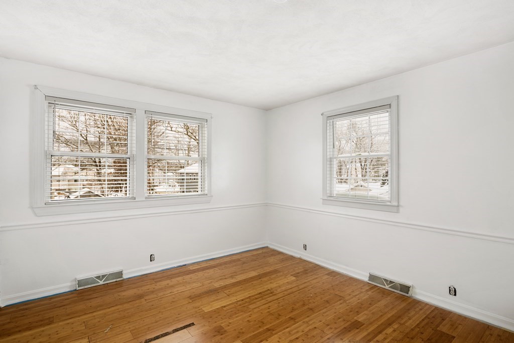 9 Fuller Road Billerica, MA 01821 - Photo 17 of 27 an empty room with wooden floor and windows