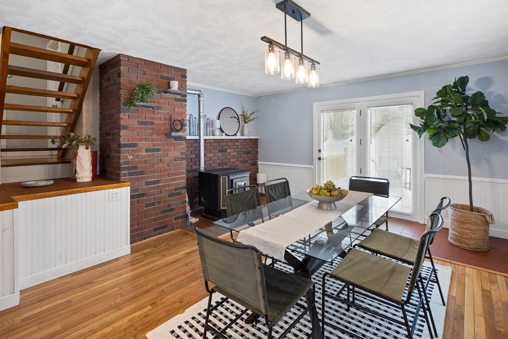 9 Fuller Road Billerica, MA 01821 - Photo 2 of 27 a living room with furniture a chandelier and a fireplace