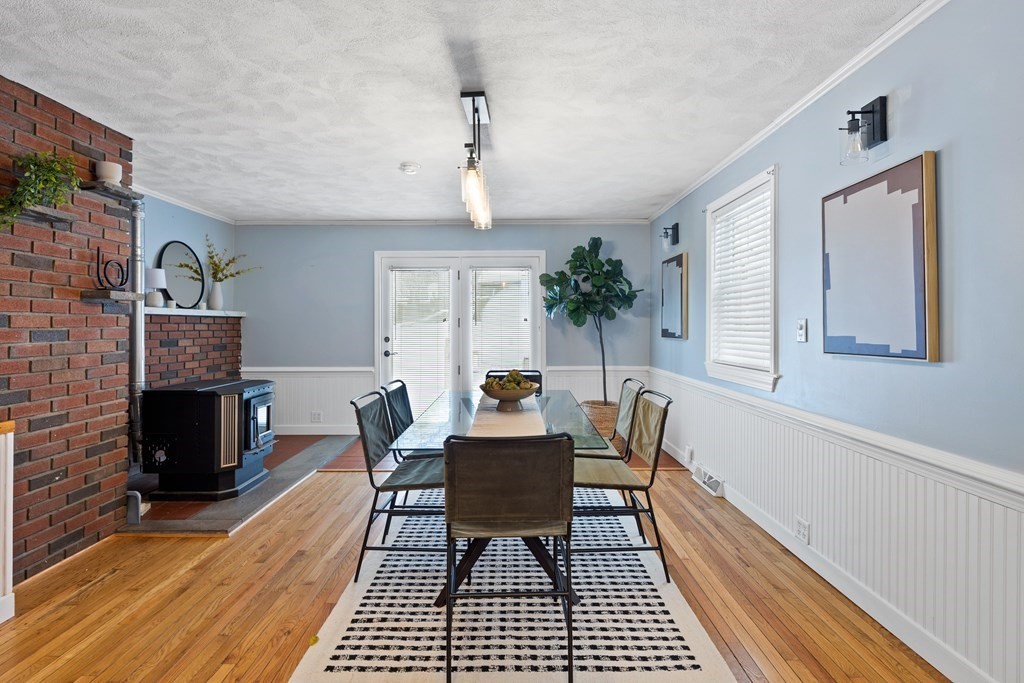 9 Fuller Road Billerica, MA 01821 - Photo 3 of 27 a dining room with furniture a rug a fireplace and a chandelier