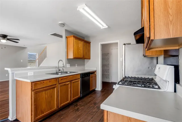 a kitchen with a sink stove and cabinets
