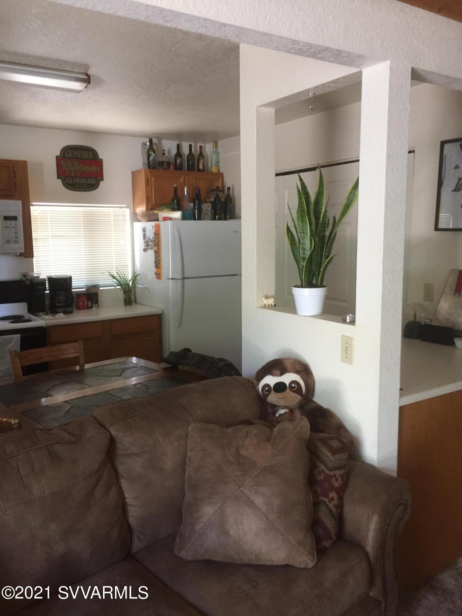 4110 East Valley Lane Rimrock, AZ 86335 - Photo 2 of 8 a black leather couch sitting in a kitchen next to a window