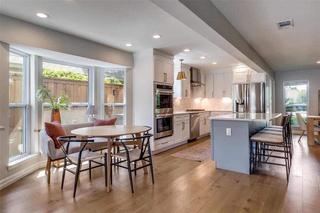 9243 Moss Farm Lane Dallas, TX 75243 - Photo 12 of 37 a view of a dining room with furniture window and wooden floor