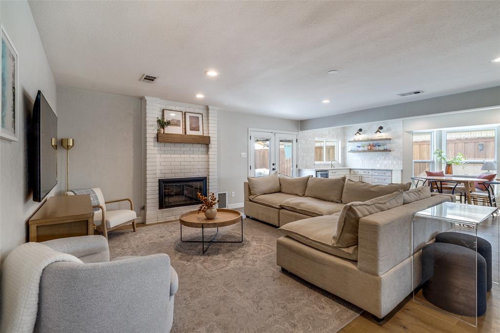 9243 Moss Farm Lane Dallas, TX 75243 - Photo 2 of 37 a living room with furniture and a fireplace