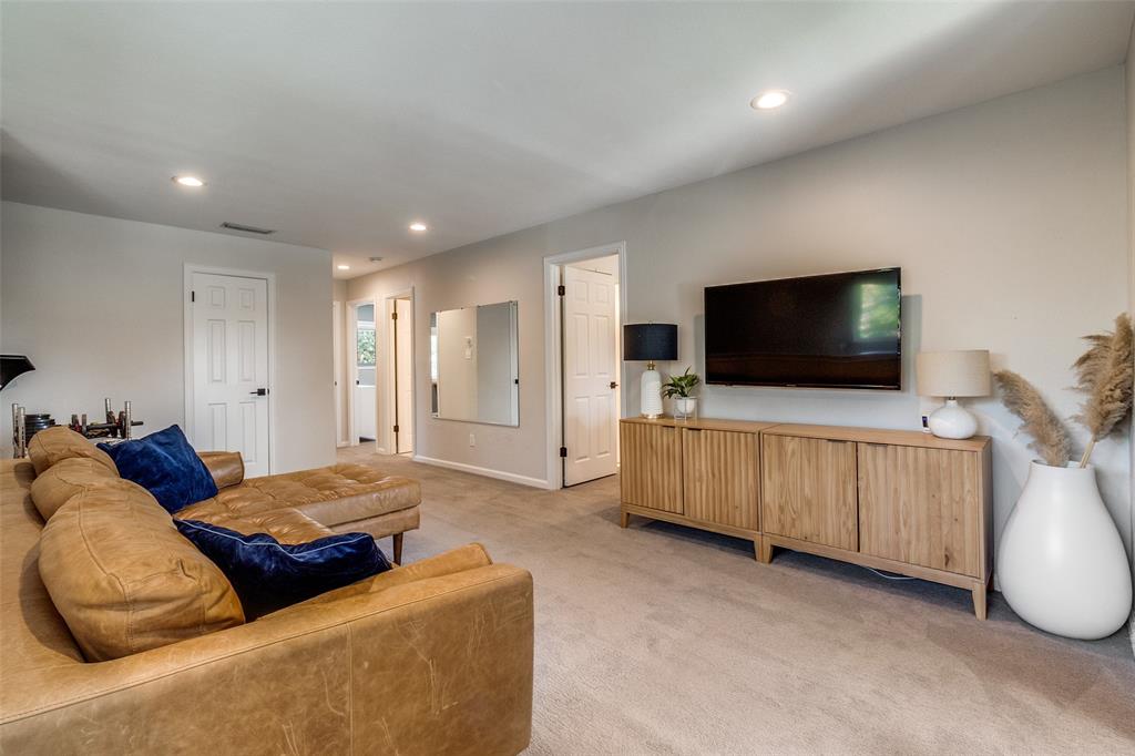 9243 Moss Farm Lane Dallas, TX 75243 - Photo 22 of 37 a living room with furniture and a flat screen tv