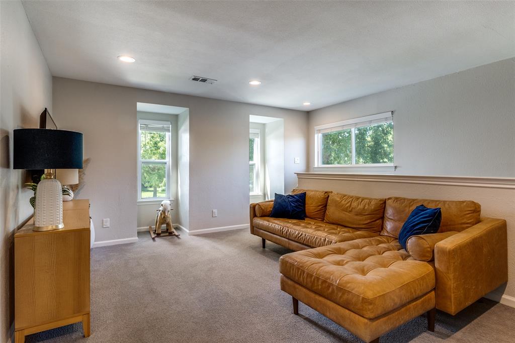 9243 Moss Farm Lane Dallas, TX 75243 - Photo 23 of 37 a living room with furniture and a flat screen tv