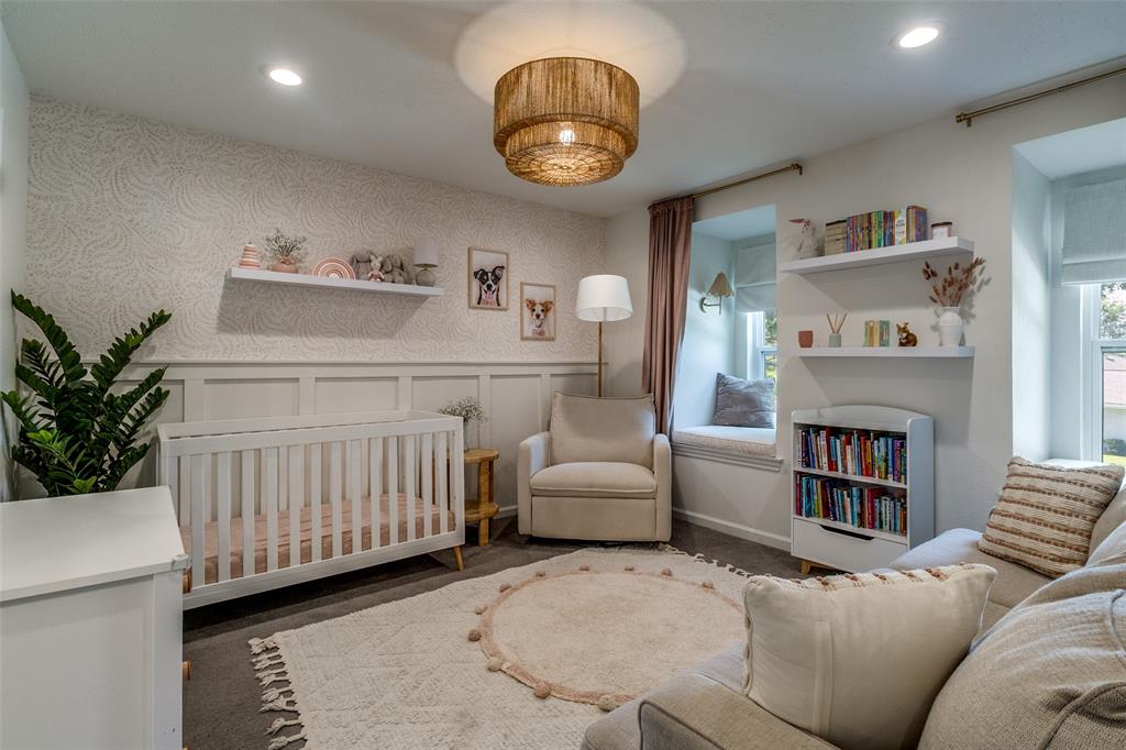 9243 Moss Farm Lane Dallas, TX 75243 - Photo 24 of 37 a bedroom with furniture and a fireplace