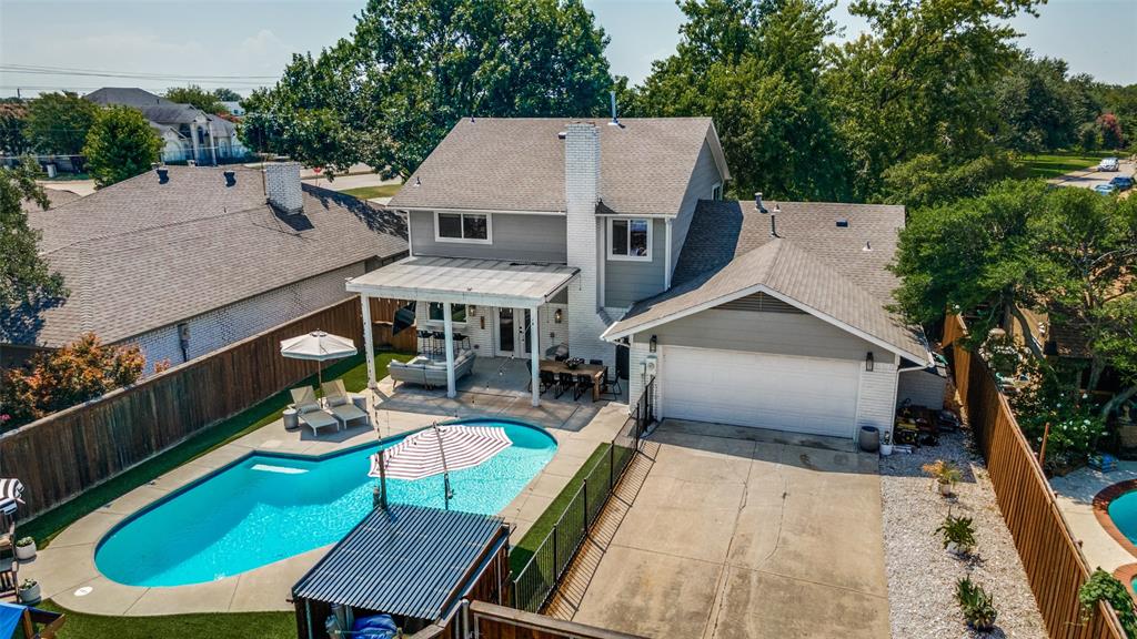 9243 Moss Farm Lane Dallas, TX 75243 - Photo 33 of 37 a view of a patio with chairs next to a yard