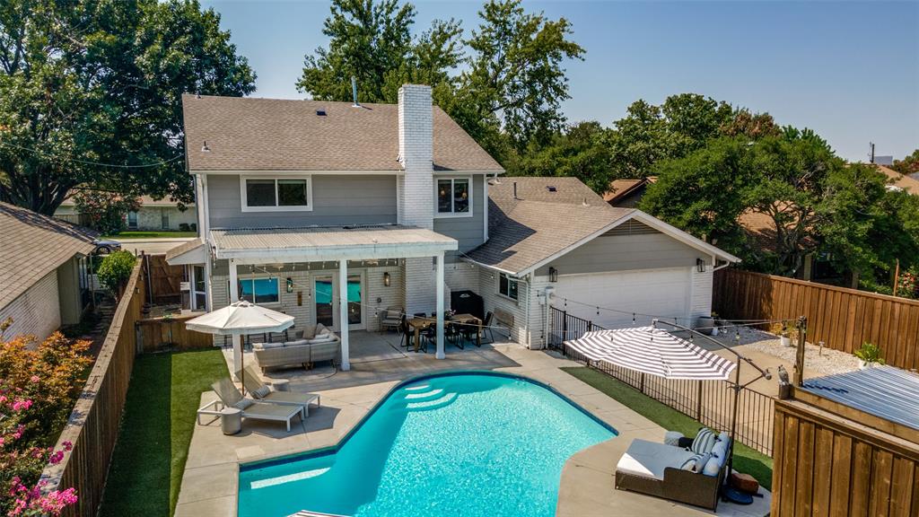 9243 Moss Farm Lane Dallas, TX 75243 - Photo 34 of 37 a view of a patio with table and chairs potted plants with wooden floor and fence