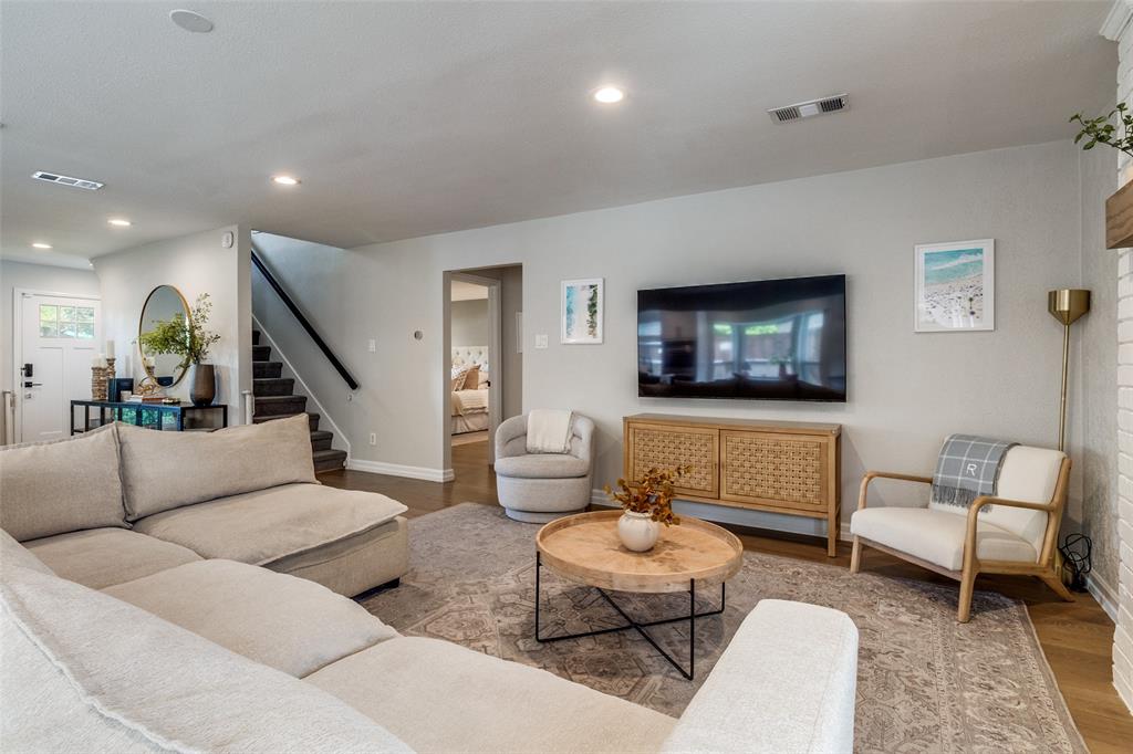 9243 Moss Farm Lane Dallas, TX 75243 - Photo 4 of 37 a living room with furniture and a flat screen tv