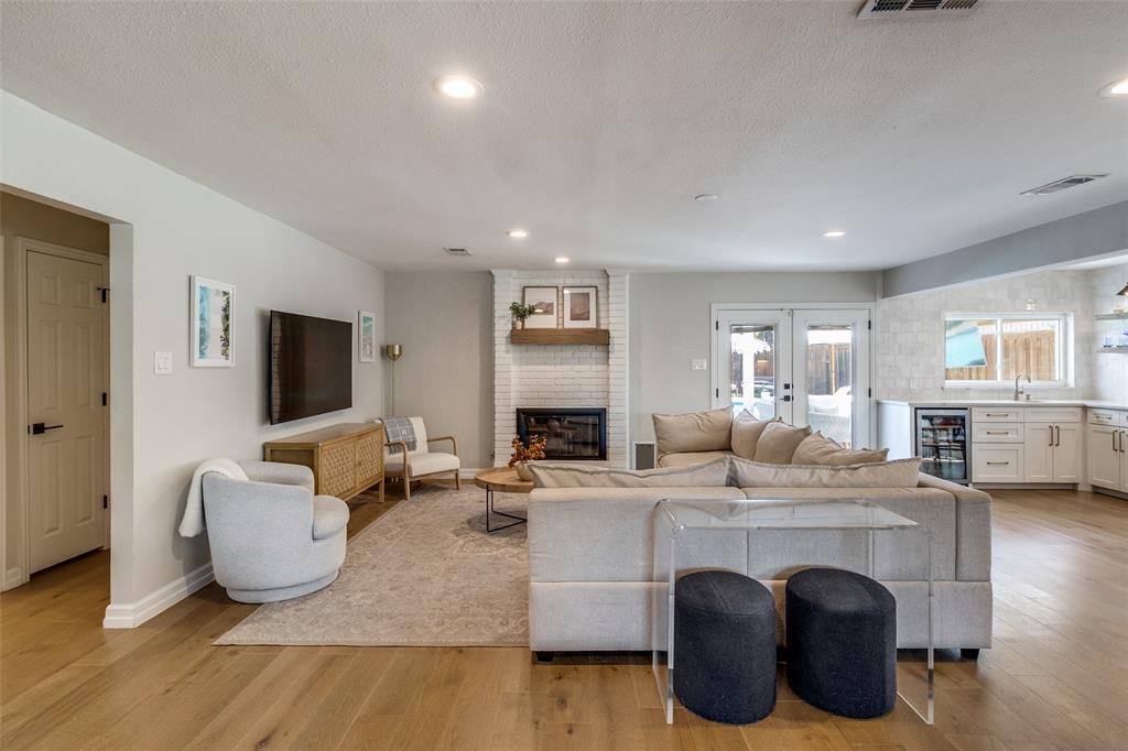 9243 Moss Farm Lane Dallas, TX 75243 - Photo 5 of 37 a living room with furniture and a wooden floor