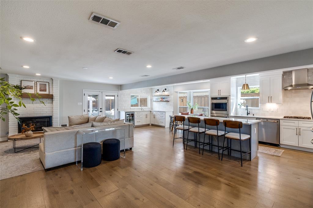 9243 Moss Farm Lane Dallas, TX 75243 - Photo 6 of 37 a living room with fireplace furniture and a wooden floor