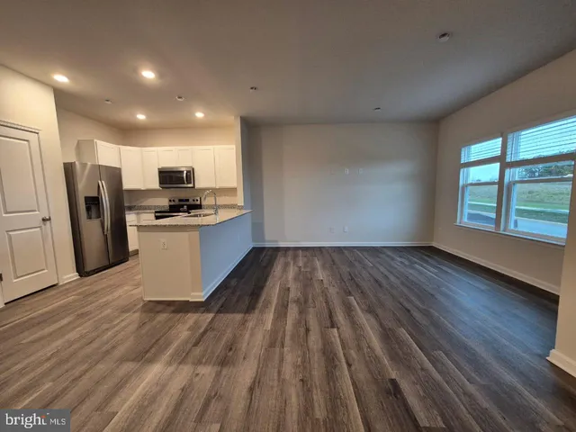 a view of kitchen with sink and wooden floor