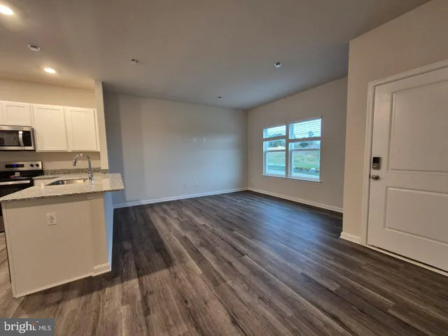a view of a kitchen with microwave and cabinets