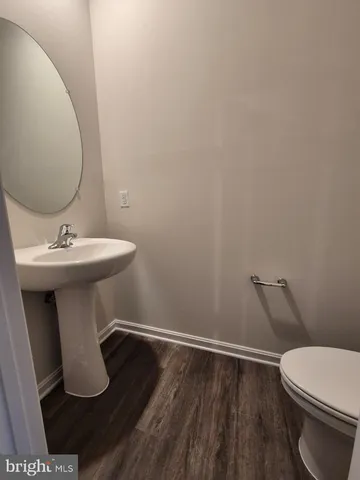 a white toilet sitting next to a bathroom sink