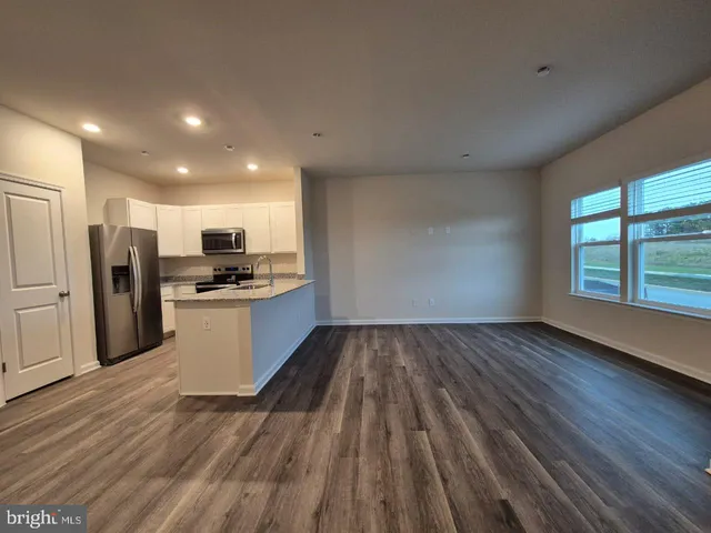 a view of kitchen with wooden floor and electronic appliances