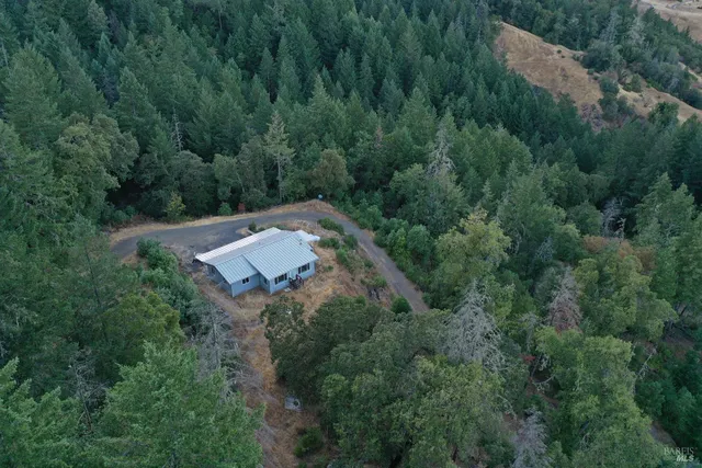 an aerial view of a house with yard and outdoor space
