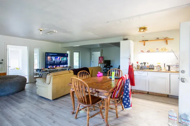 a dining room with a wooden table and chairs