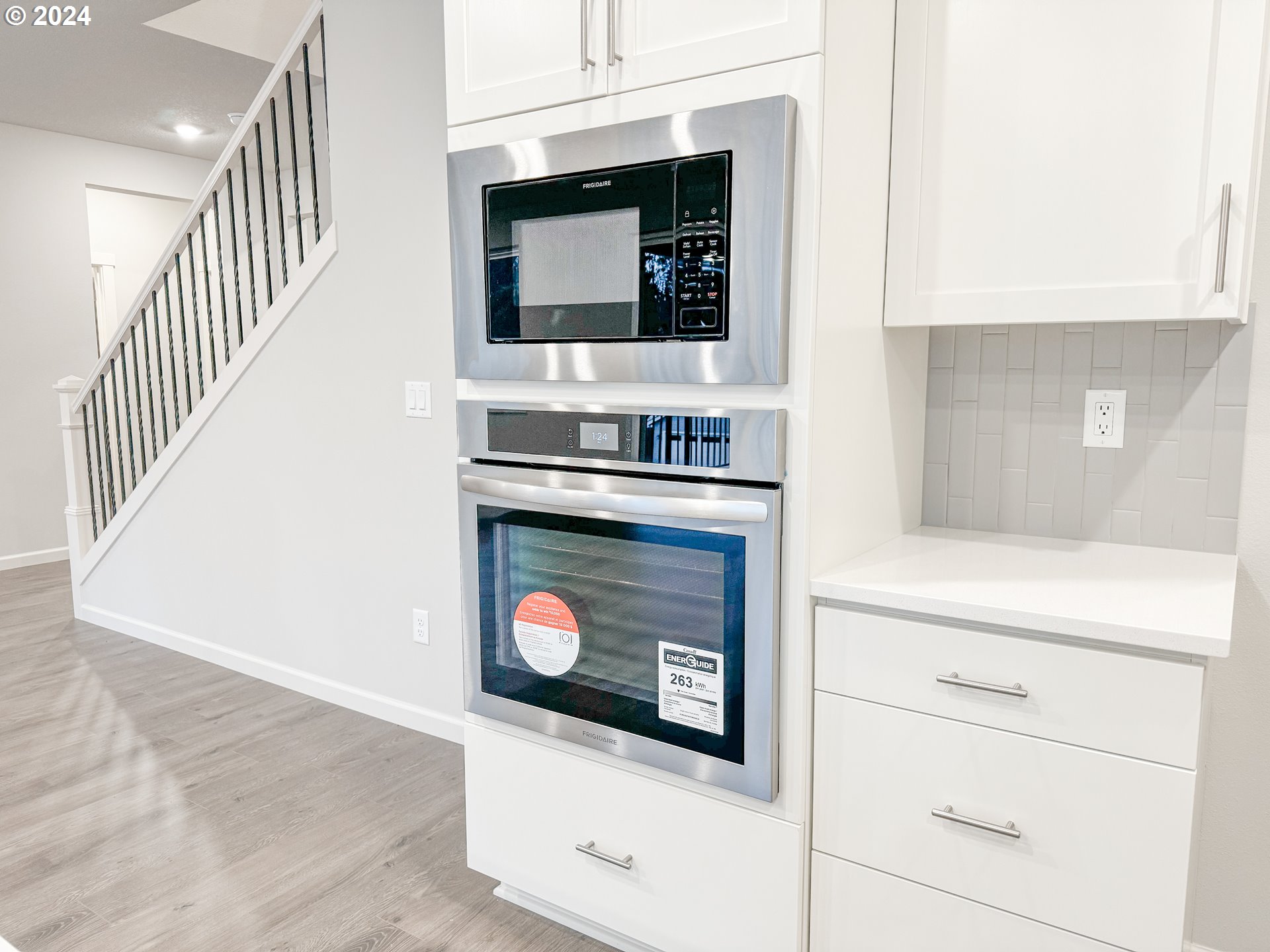 2632 South 8th Way Ridgefield, WA 98642 - Photo 5 of 28 a kitchen with granite countertop white cabinets and white appliances