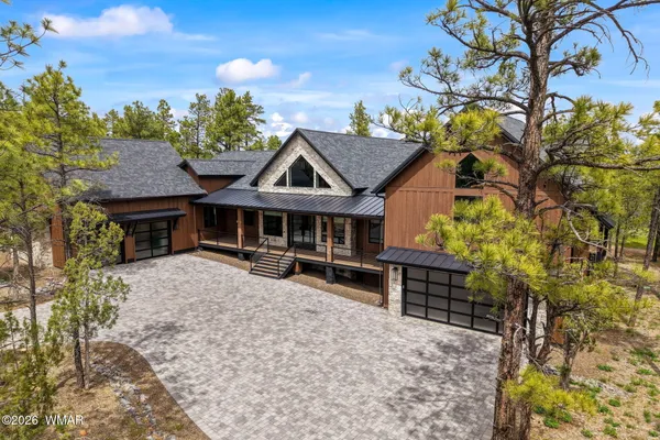 a dining hall with stainless steel appliances kitchen island granite countertop a dining table and chairs
