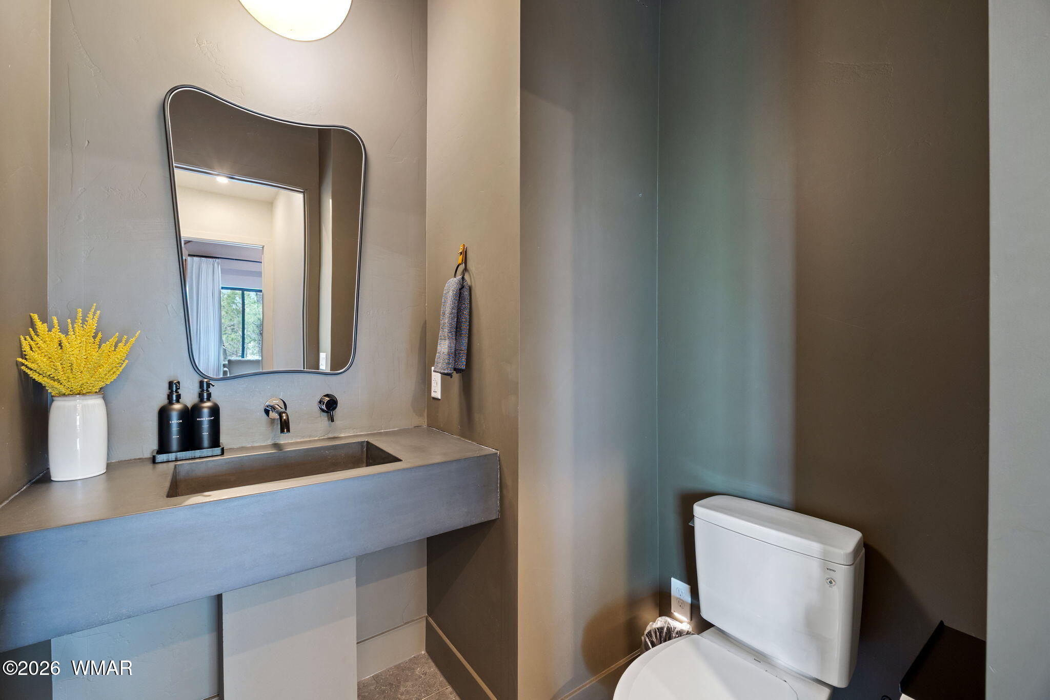2441 South Monkshood Road Show Low, AZ 85901 - Photo 27 of 90 a bathroom with a toilet sink and mirror