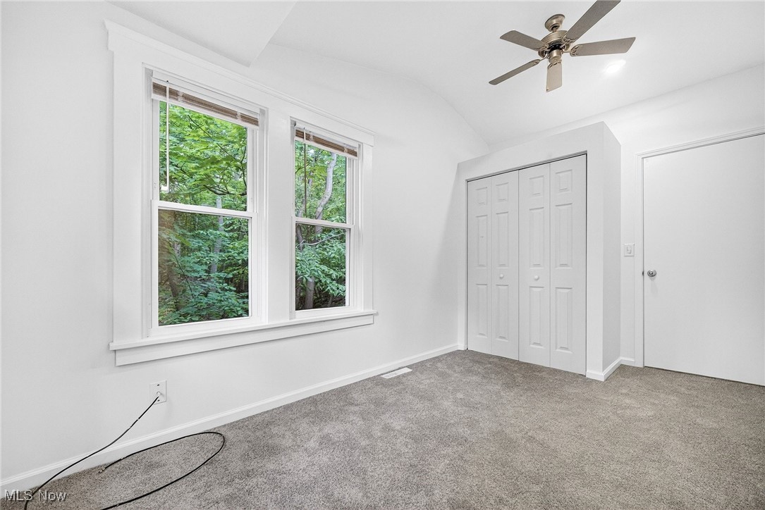 4669 Liberty Road Cleveland, OH 44121 - Photo 15 of 30 Unfurnished bedroom with vaulted ceiling, carpet flooring, ceiling fan, and a closet
