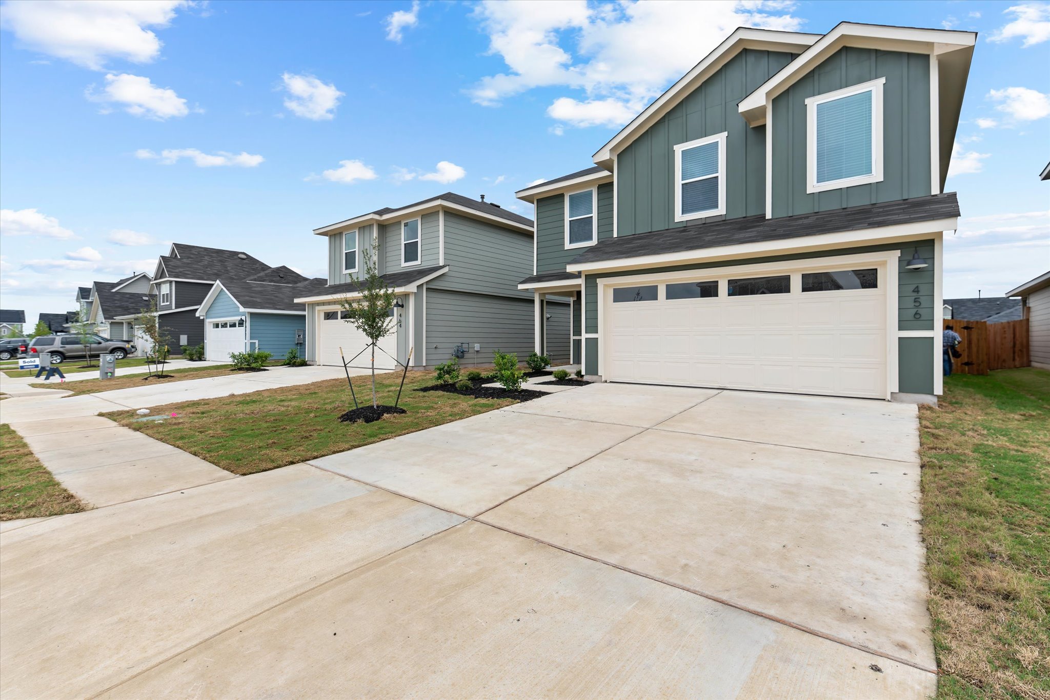 456 Sandringham Loop Kyle, TX 78640 - Photo 3 of 40 A row of modern homes showcases ample driveway space and well-maintained front yards.