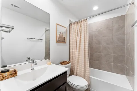 a bedroom with a bed and flowerpot