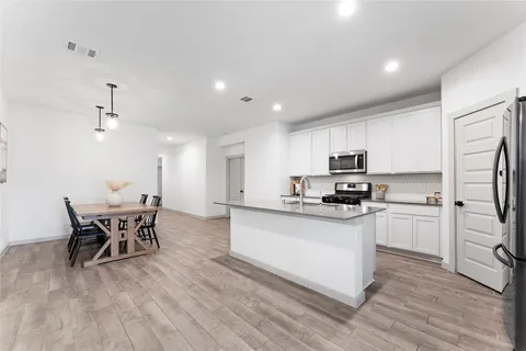 a dining room with furniture and wooden floor